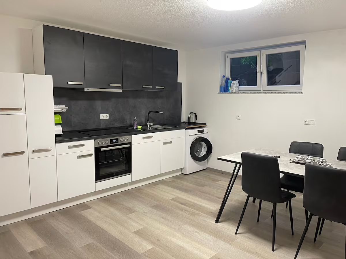Voll ausgestattete Küche mit Backofen, Waschmaschine und Essplatz